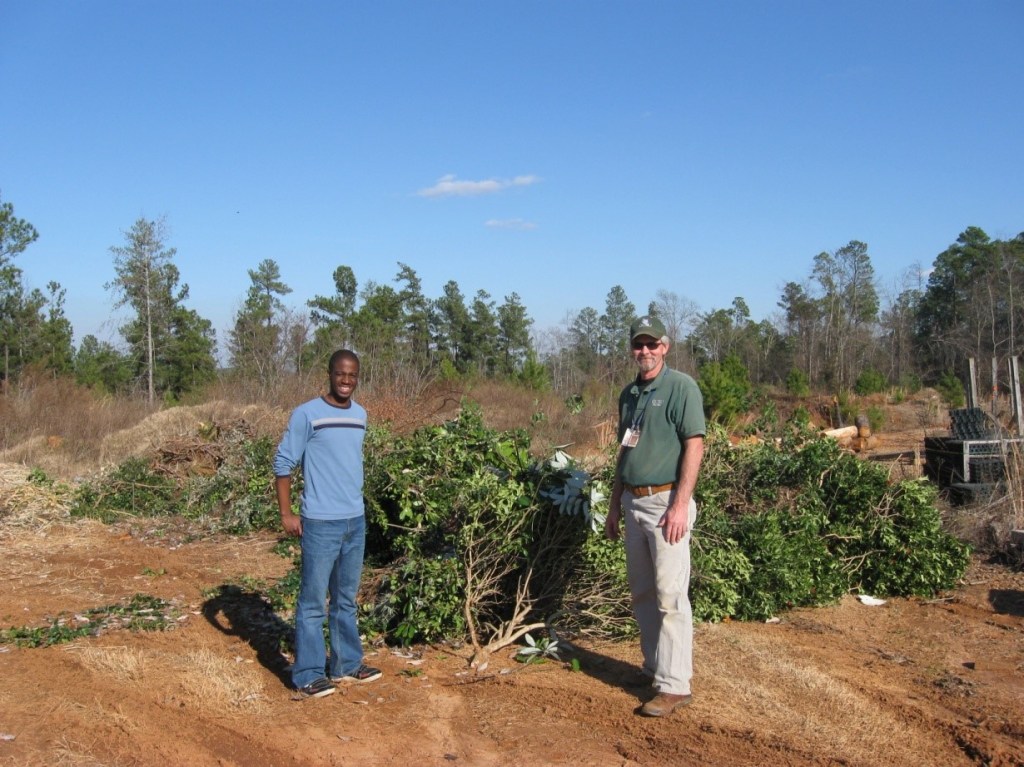 Chris Chenga and Groundskeeper Jack Hill standing in front of trimmings ready to be composted.